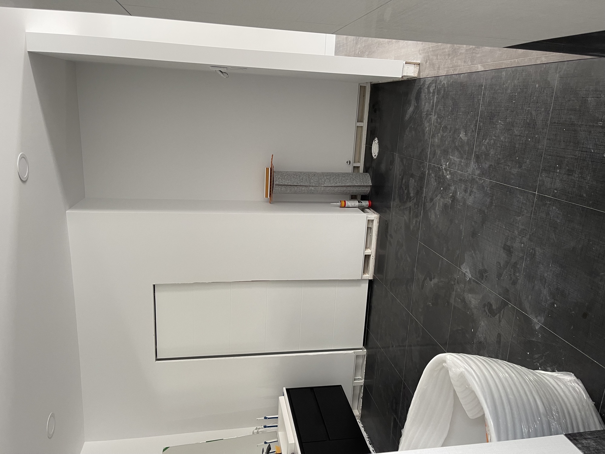 Spacious bathroom with large tiles.